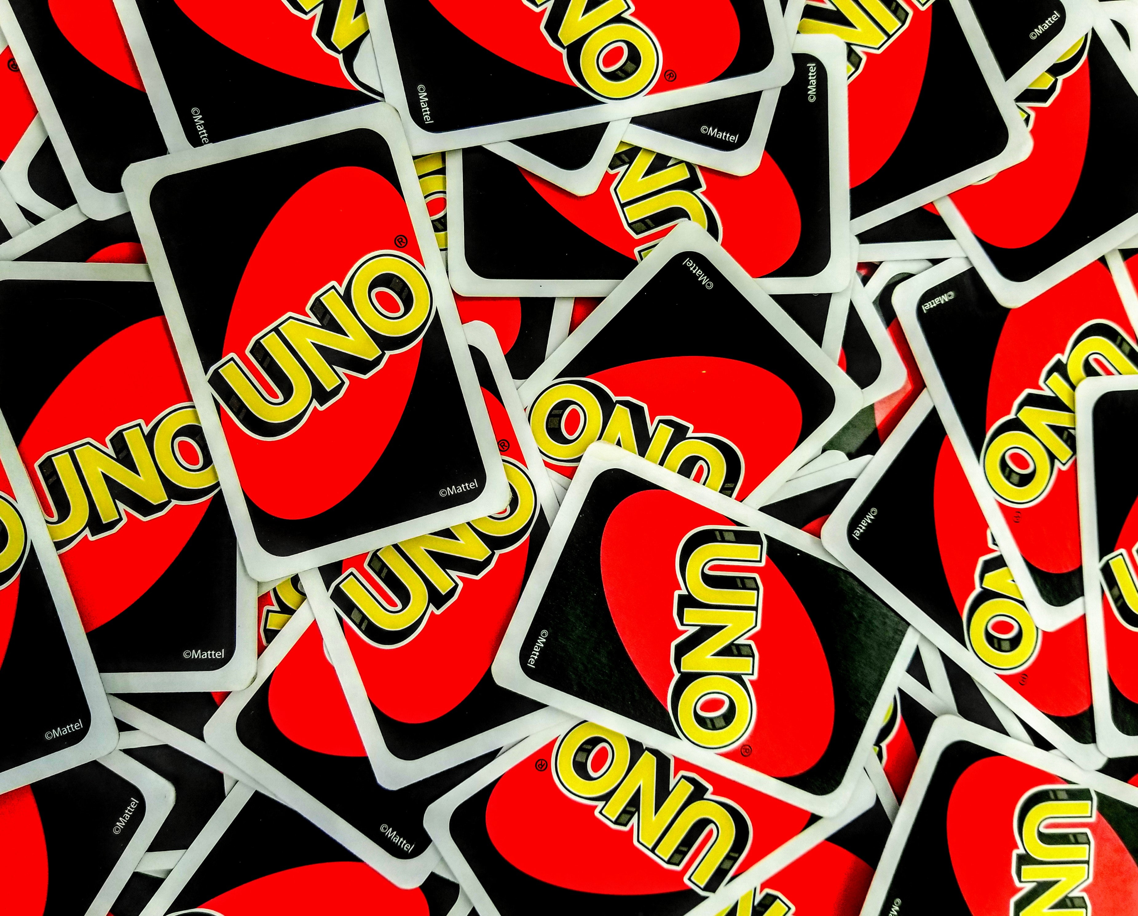 A collage of "Uno" cards piled among each other.